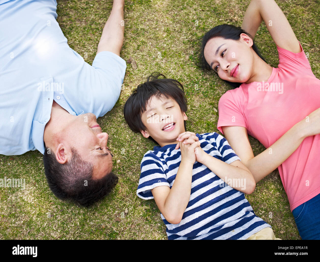 boy lying on grass making a wish Stock Photo