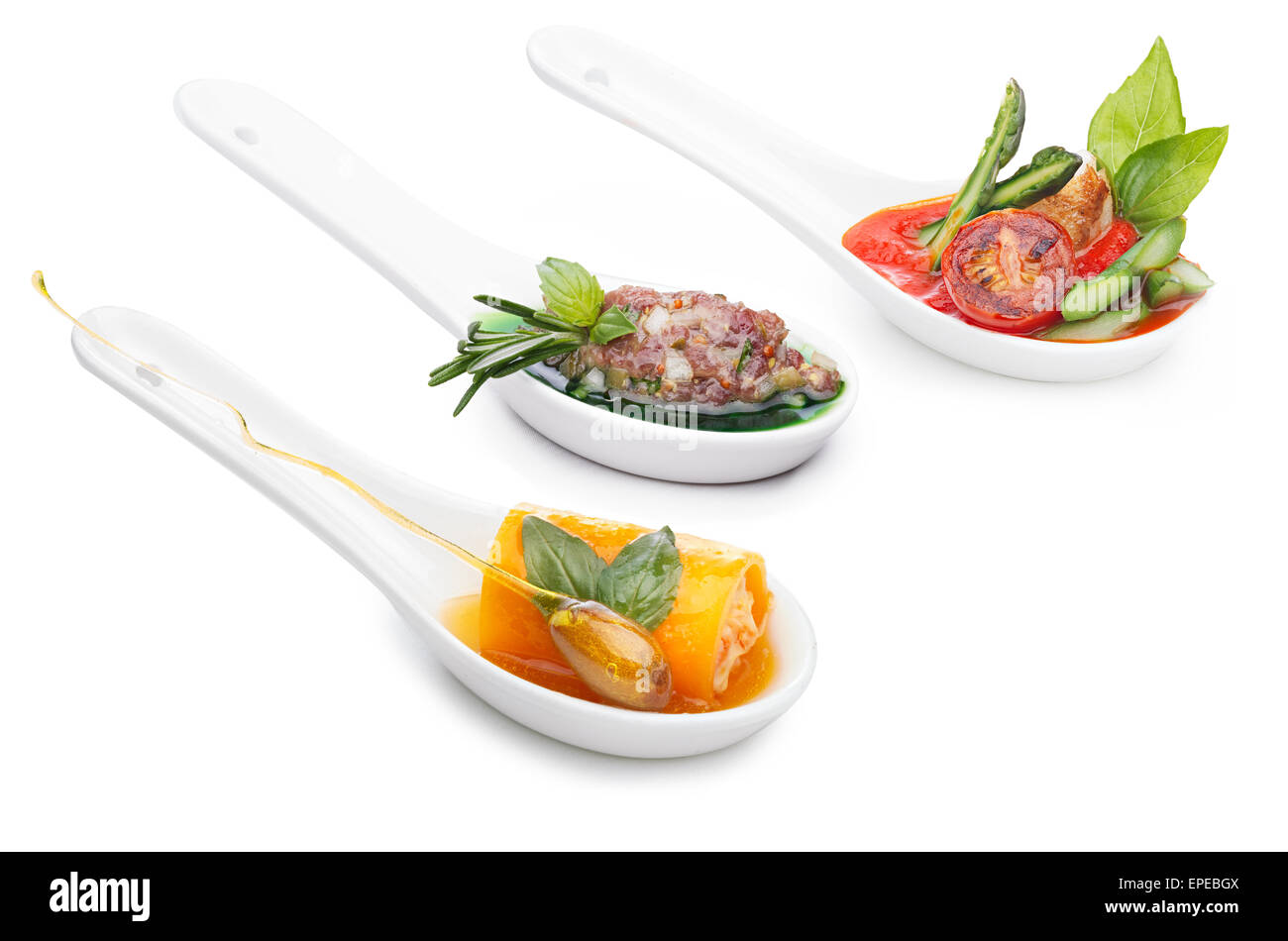 Variety of appetizers in ceramic spoons. Snacks. Finger food. Stock Photo