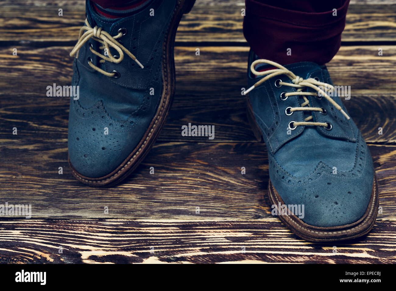 Close up of men's brogues (also known as derbies,gibsons or wingtips) made from blue oiled suede. Vintage styled Stock Photo