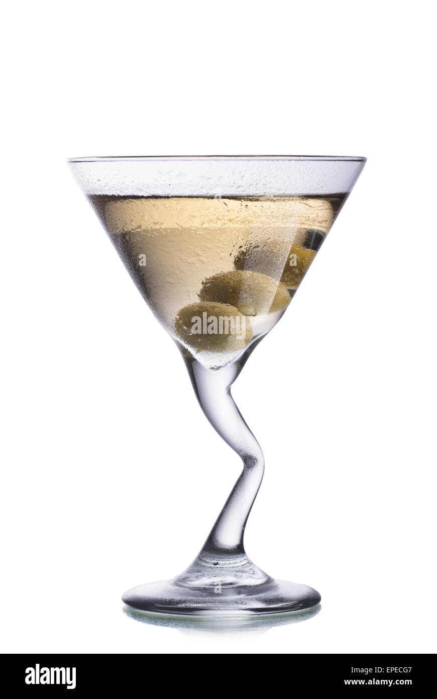 Dirty Martini alcoholic cocktail with olives inside the glass with bent leg Stock Photo