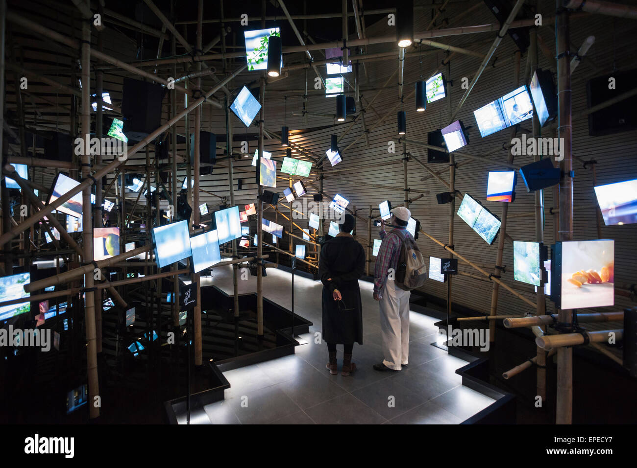 Exhibition hall with irregular arrangement of multimedia screens. Milan