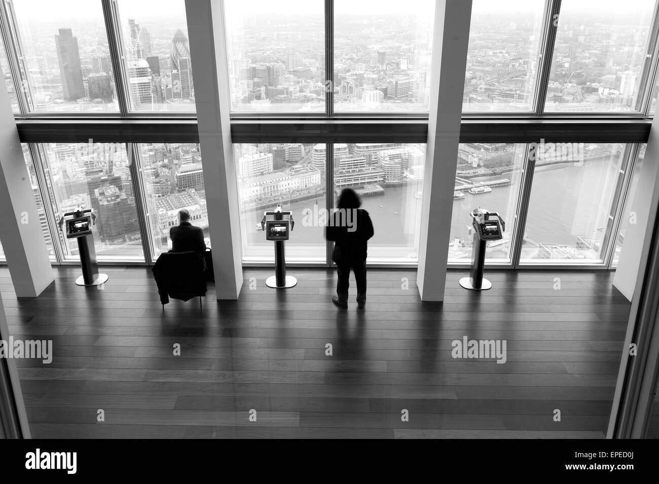 Two people looking at the City of London. The Shard, London, United Kingdom. Architect: Renzo Piano Building Workshop, 2012. Stock Photo