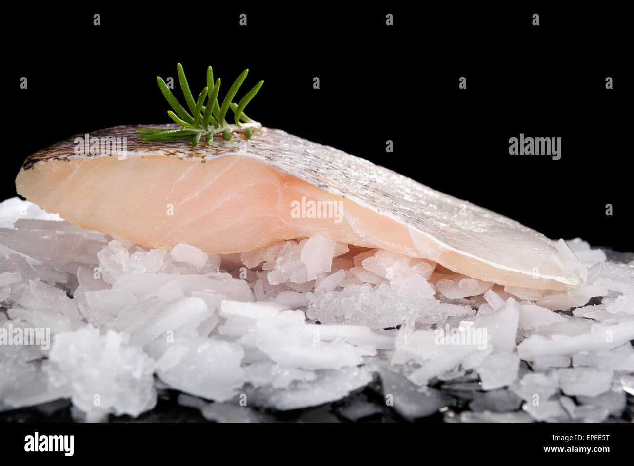 Fresh fish on crushed ice isolated on black background. Culinary fresh fish eating. Stock Photo