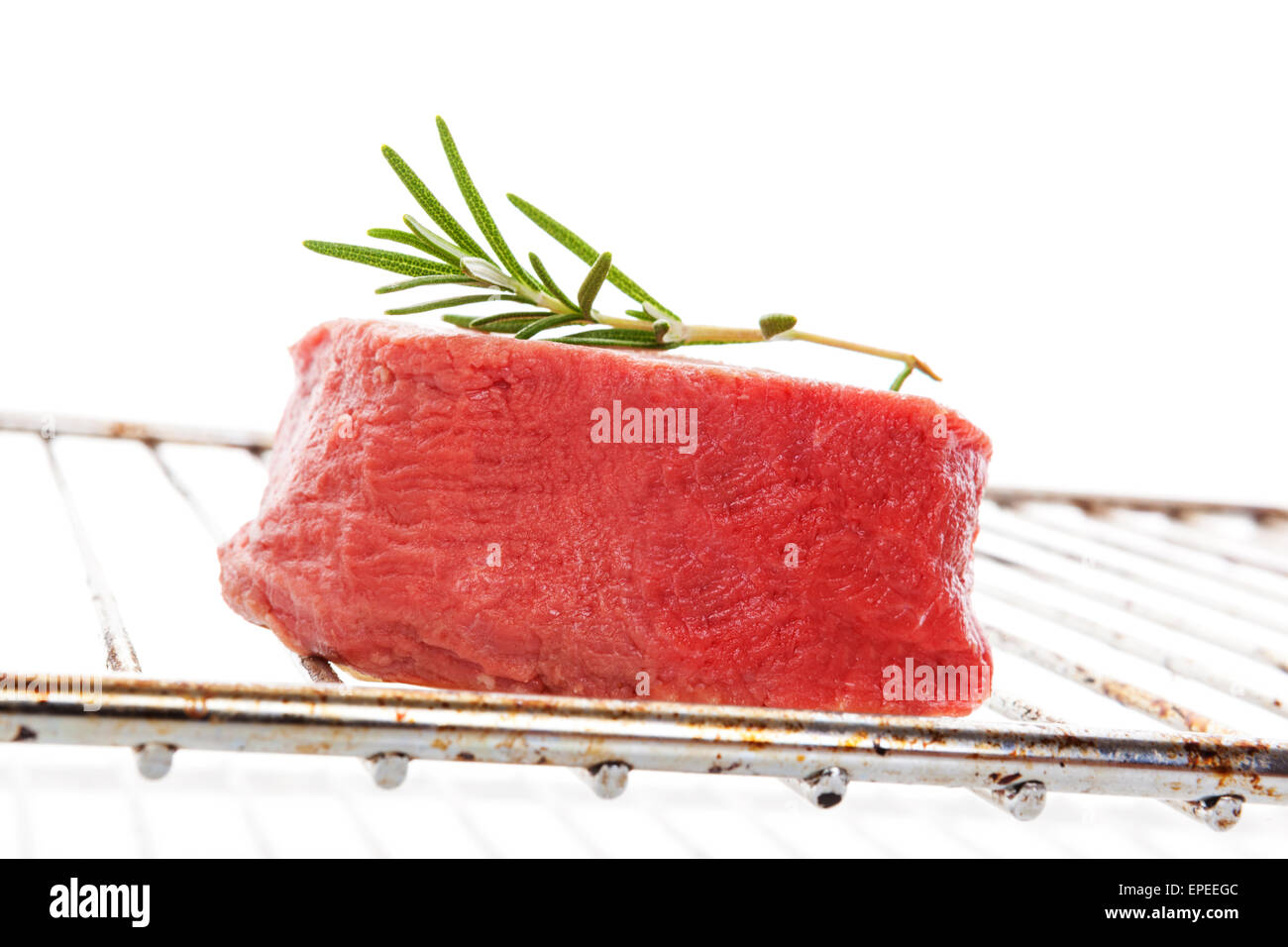 Big raw beefsteak on grill isolated on white background. Culinary delicious red meat eating. Stock Photo