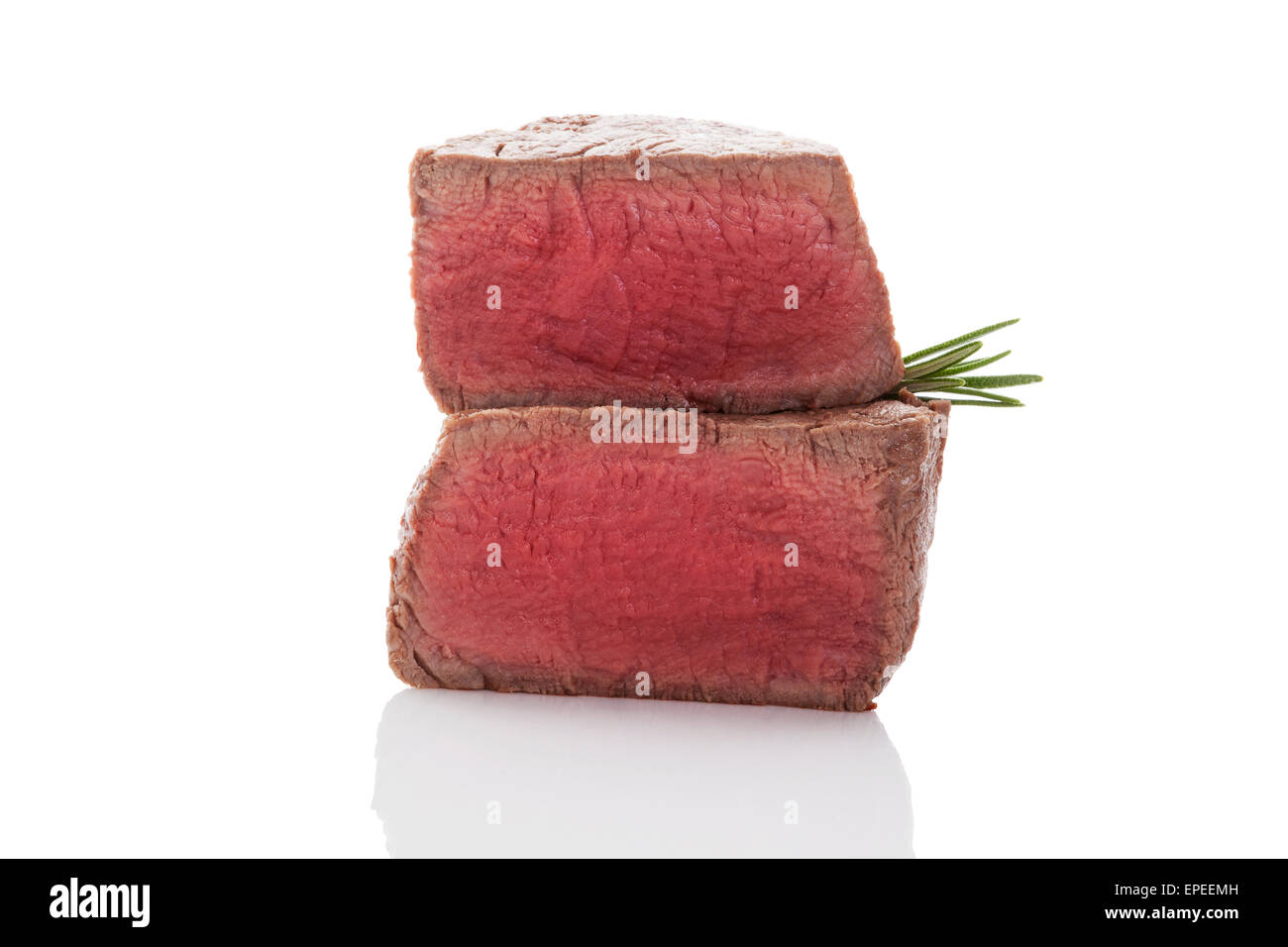 Beefsteak. Big steak with fresh herbs isolated on white background. Culinary red meat eating. Stock Photo