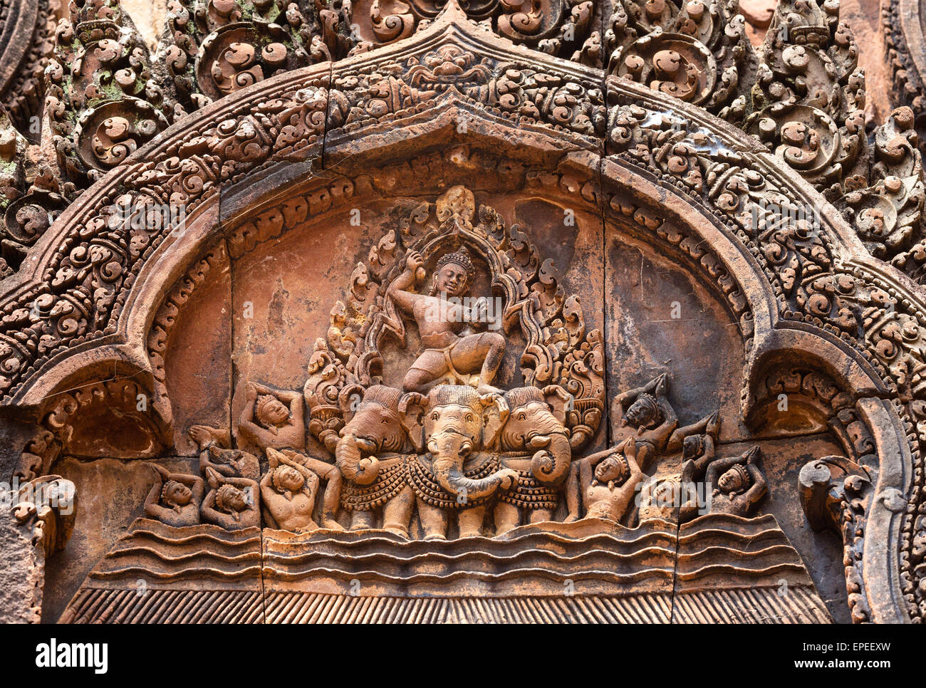 Bas-relief at the entrance of the northern library, Indra on his three-headed elephant, Khmer Hindu temple Banteay Srei Stock Photo