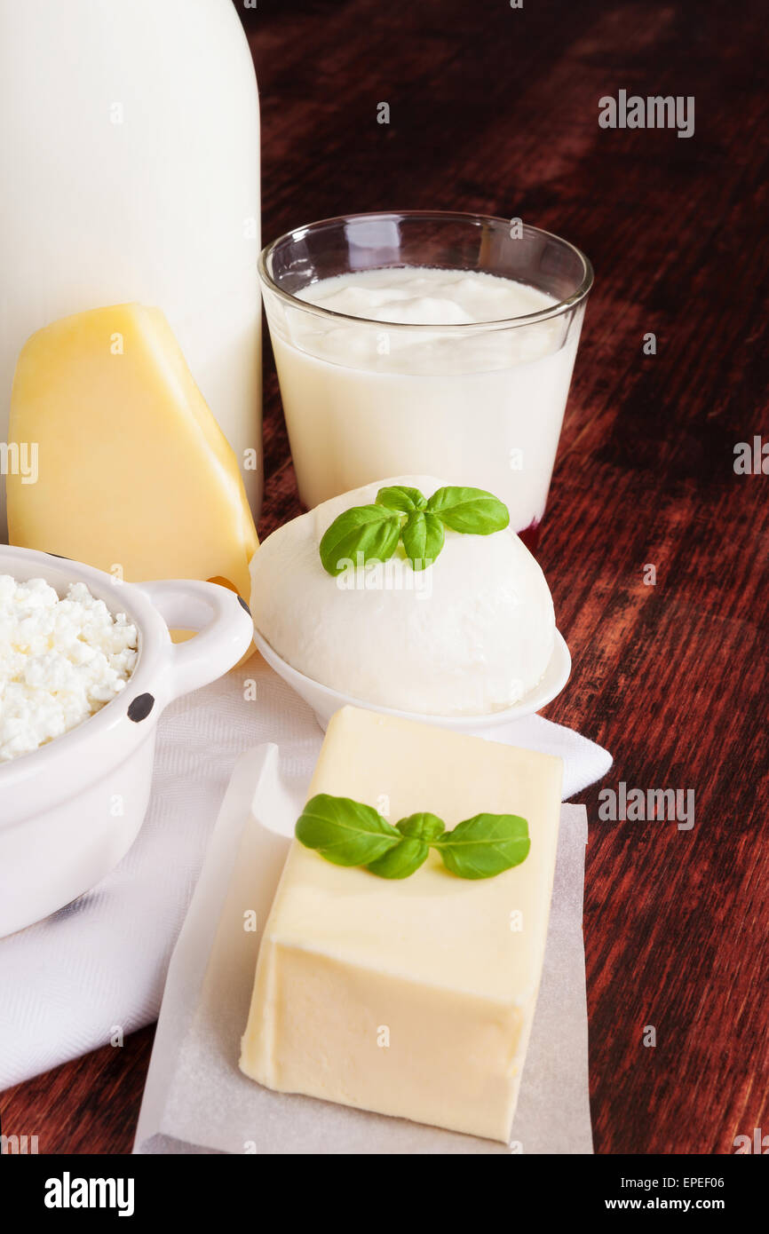 Dairy products milk, cheese, yogurt and curd on dark wooden background