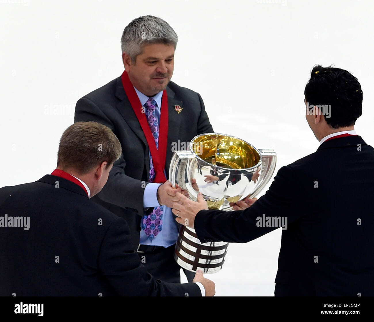 Canadian team head coach Todd McLellan receives the trophy after his