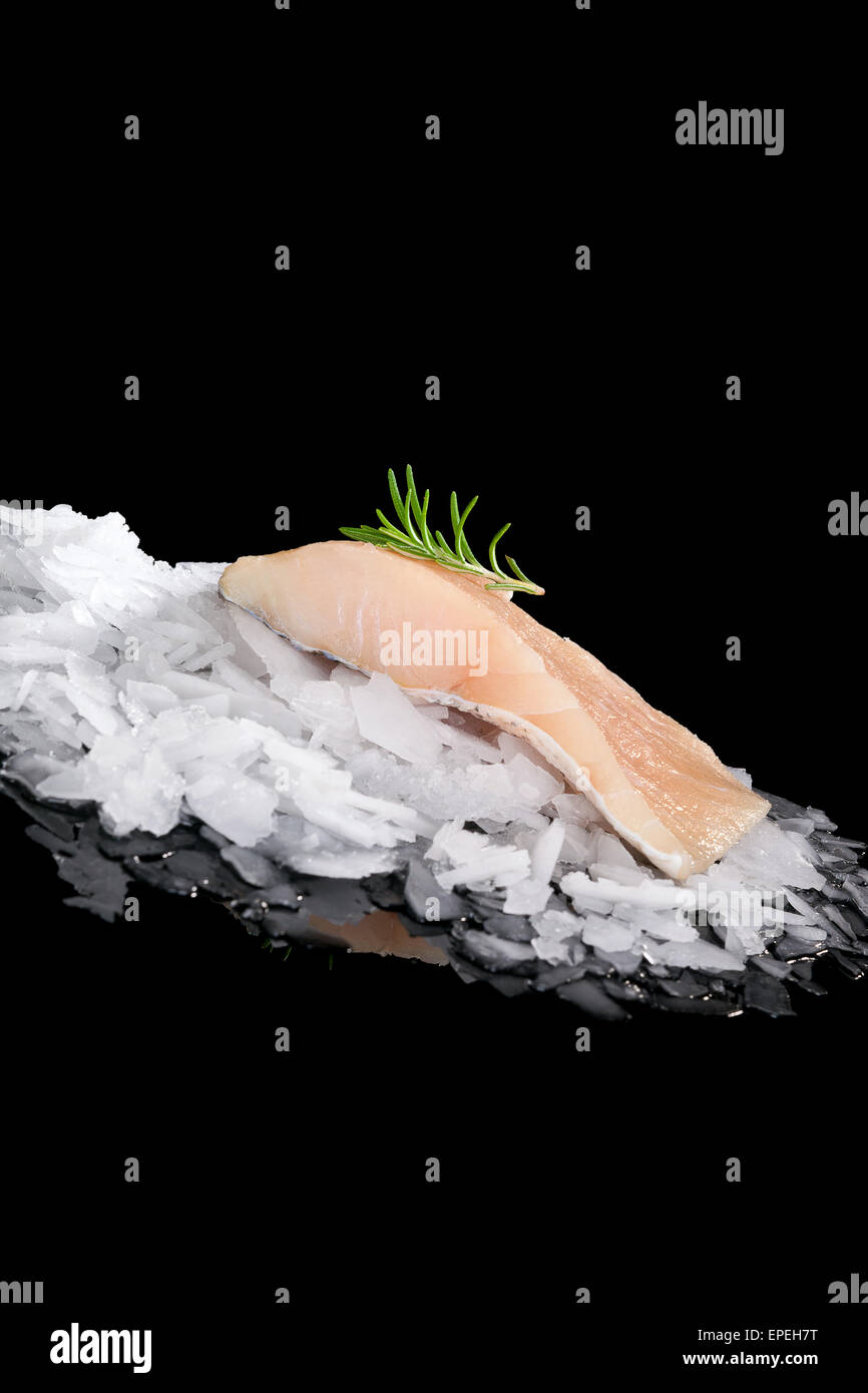 Fresh fish on crushed ice isolated on black background. Culinary fresh fish eating. Stock Photo