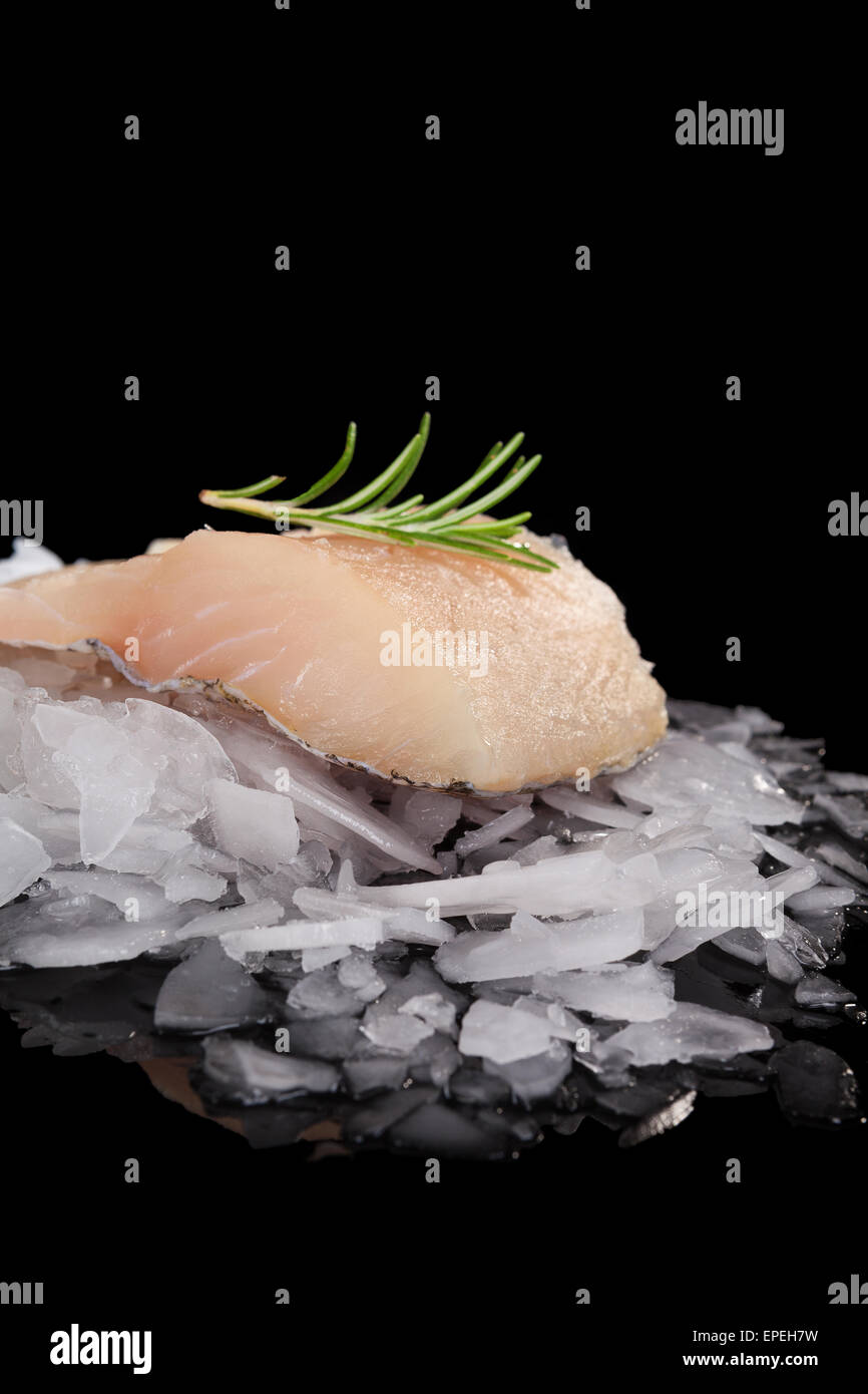 Fresh fish on crushed ice isolated on black background. Culinary fresh fish eating. Stock Photo