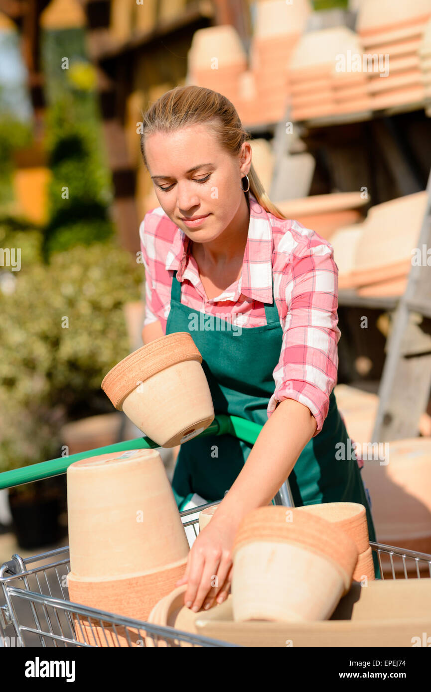Garden center woman putting clay pots cart Stock Photo