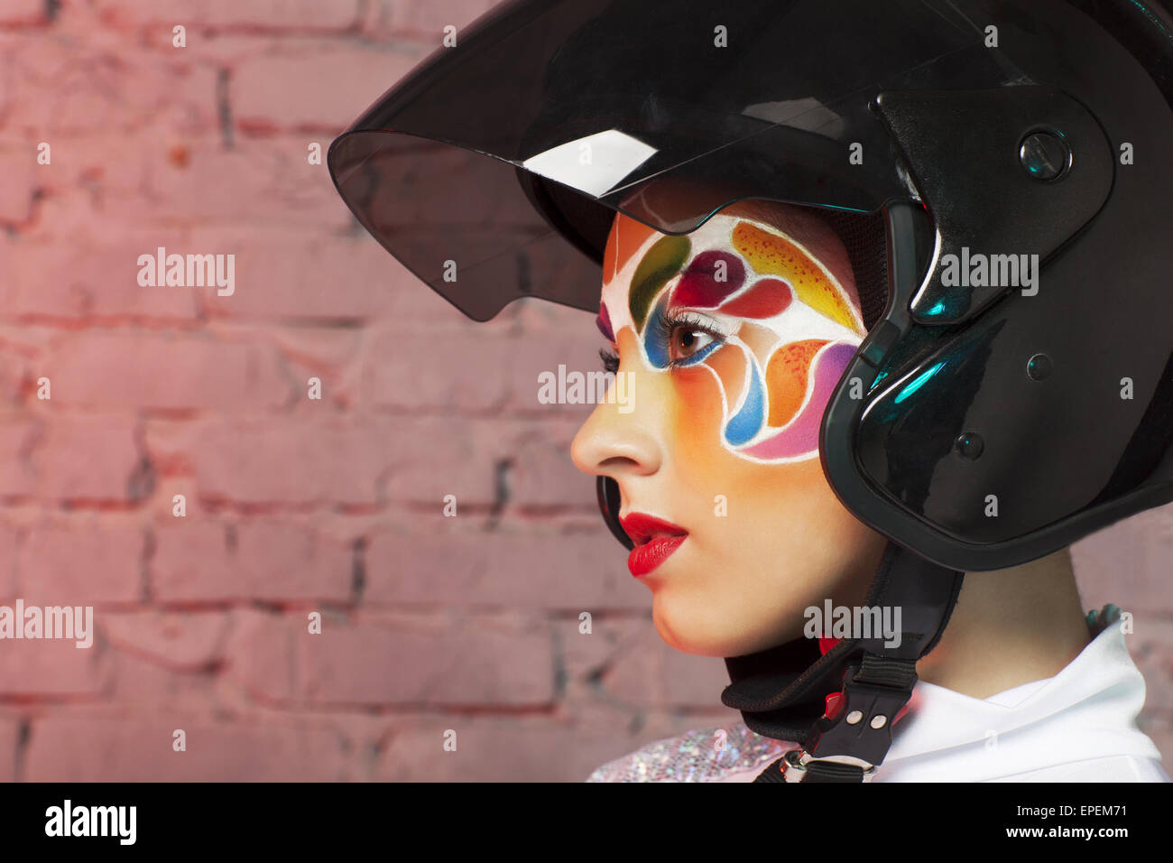 Beautiful young model with bright creative make up with helmet Stock ...