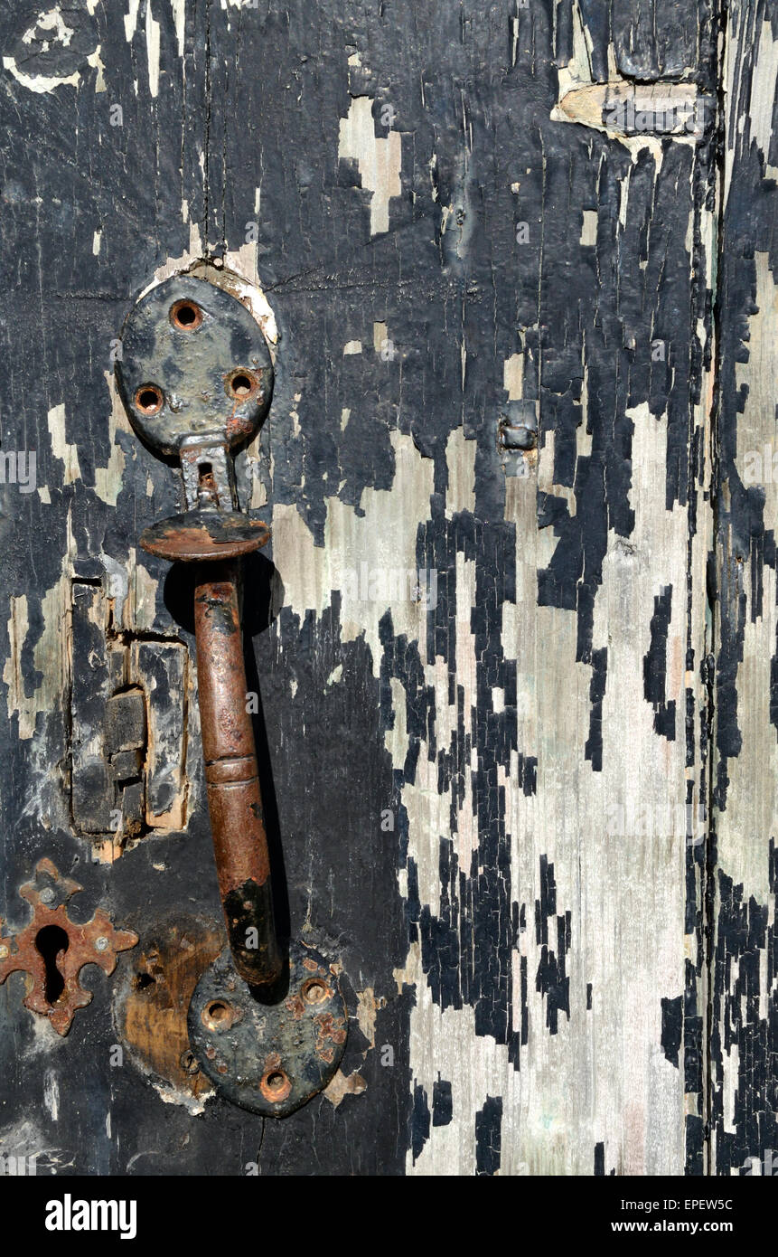 Old broken iron lock and peeling paint on a church door Cwm Pennant Llanfihangel Gwynedd Wales Stock Photo