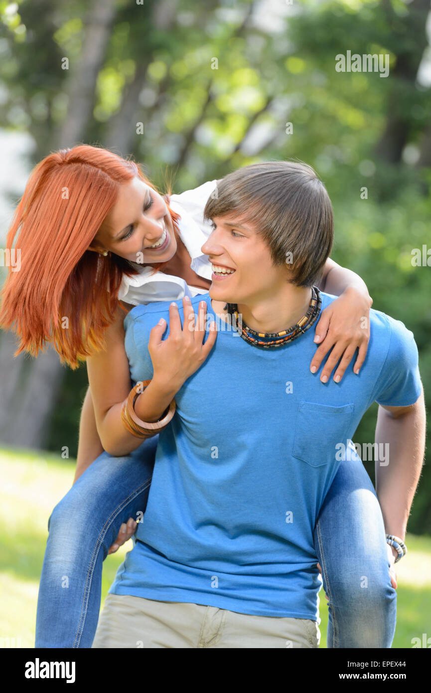 Man give piggyback ride to girlfriend park Stock Photo - Alamy