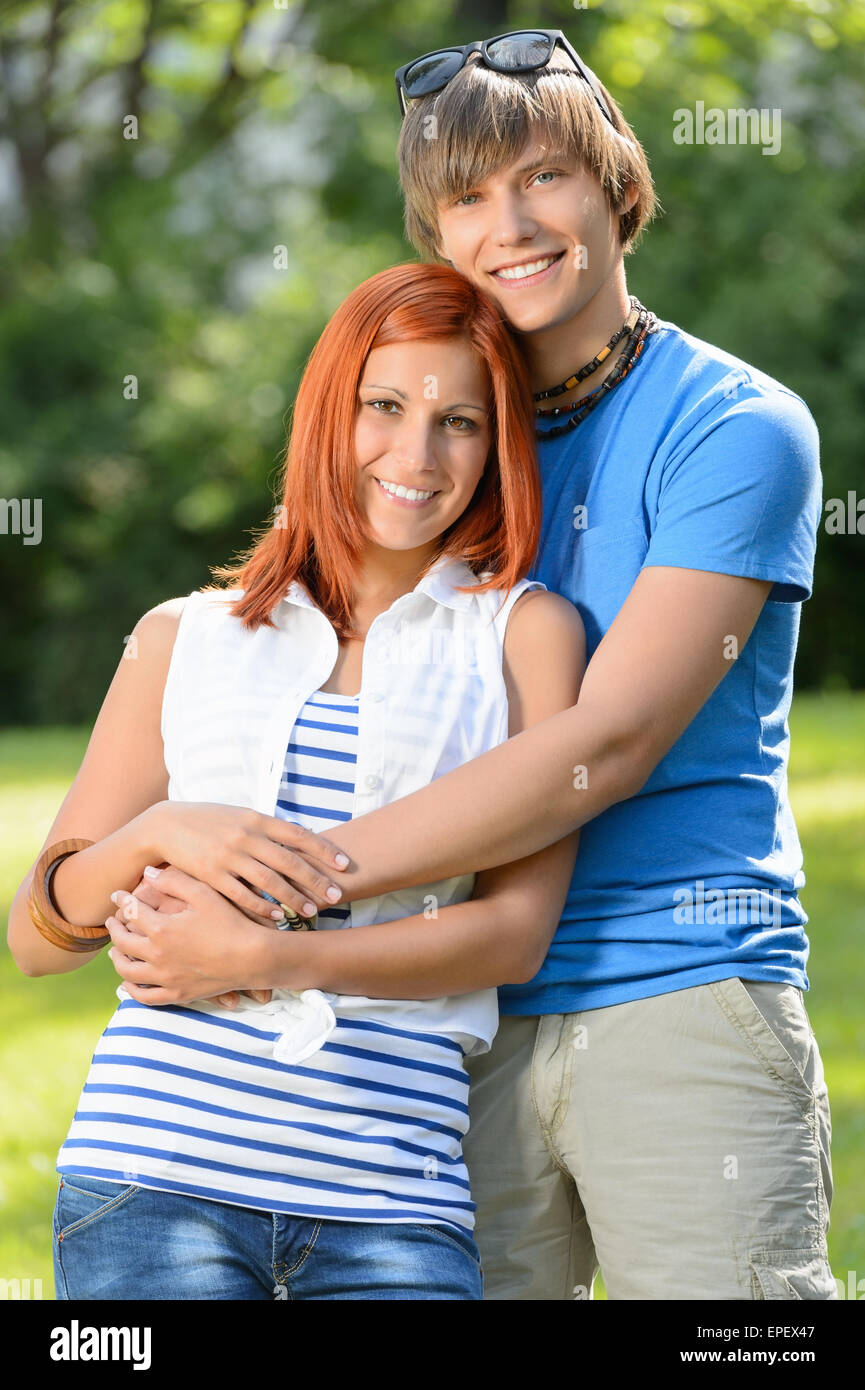 Romantic teenage couple hugging in sunny park Stock Photo - Alamy