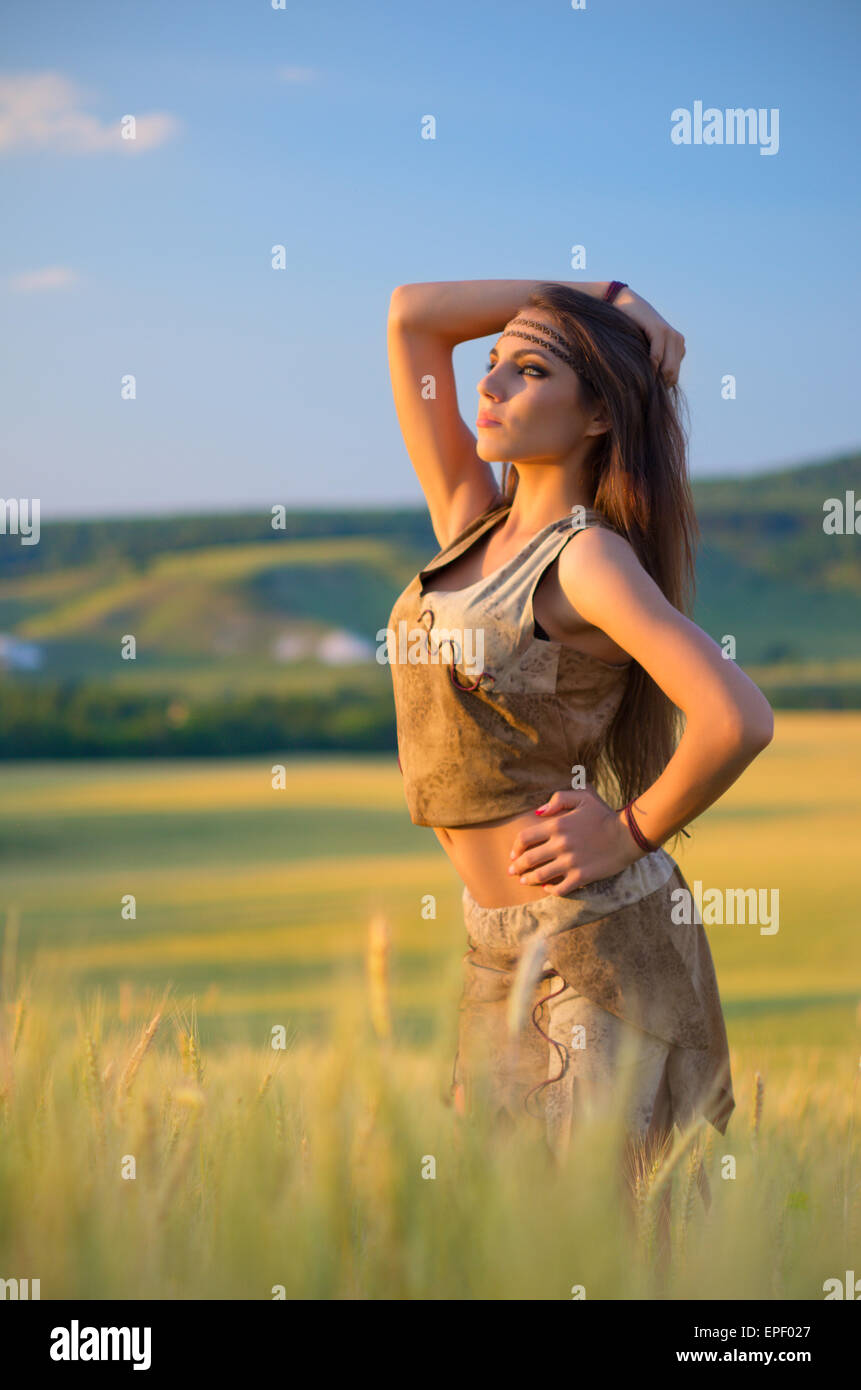 Young girl in wheat field at sunset Stock Photo - Alamy