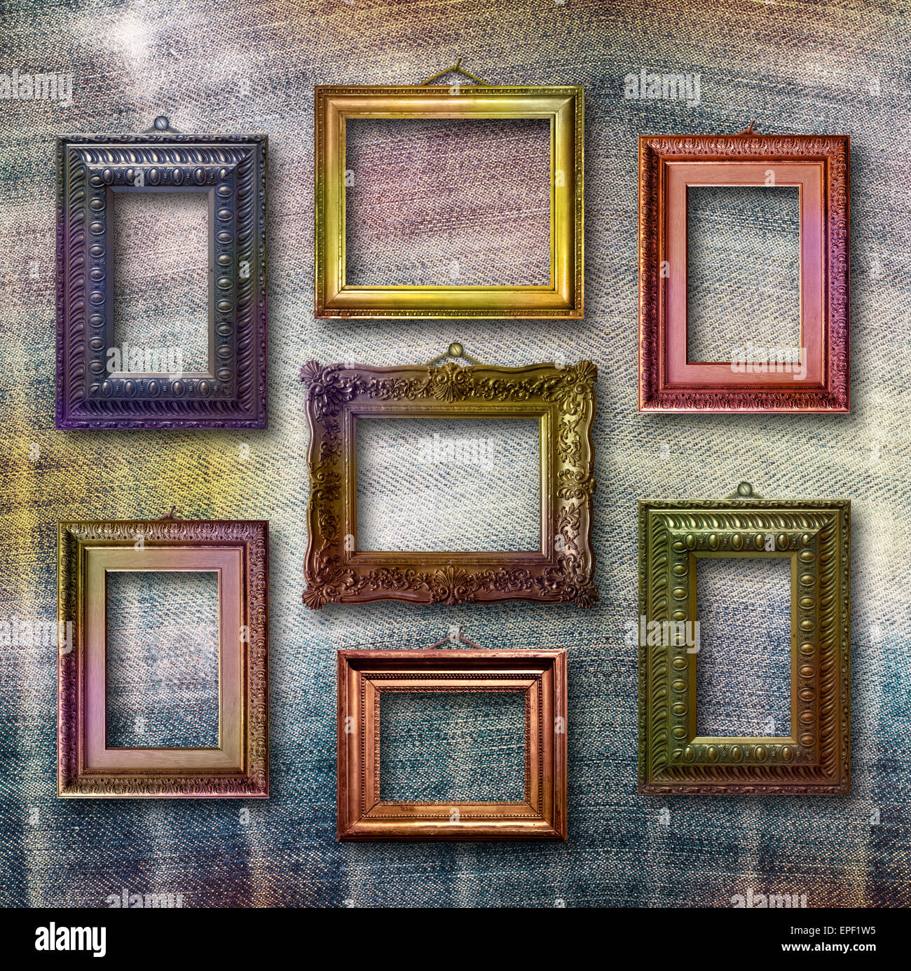 Gilded wooden frames for pictures on blue jeans background Stock Photo