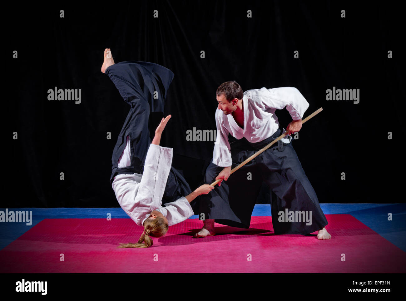 Fight between two aikido fighters on black Stock Photo Alamy