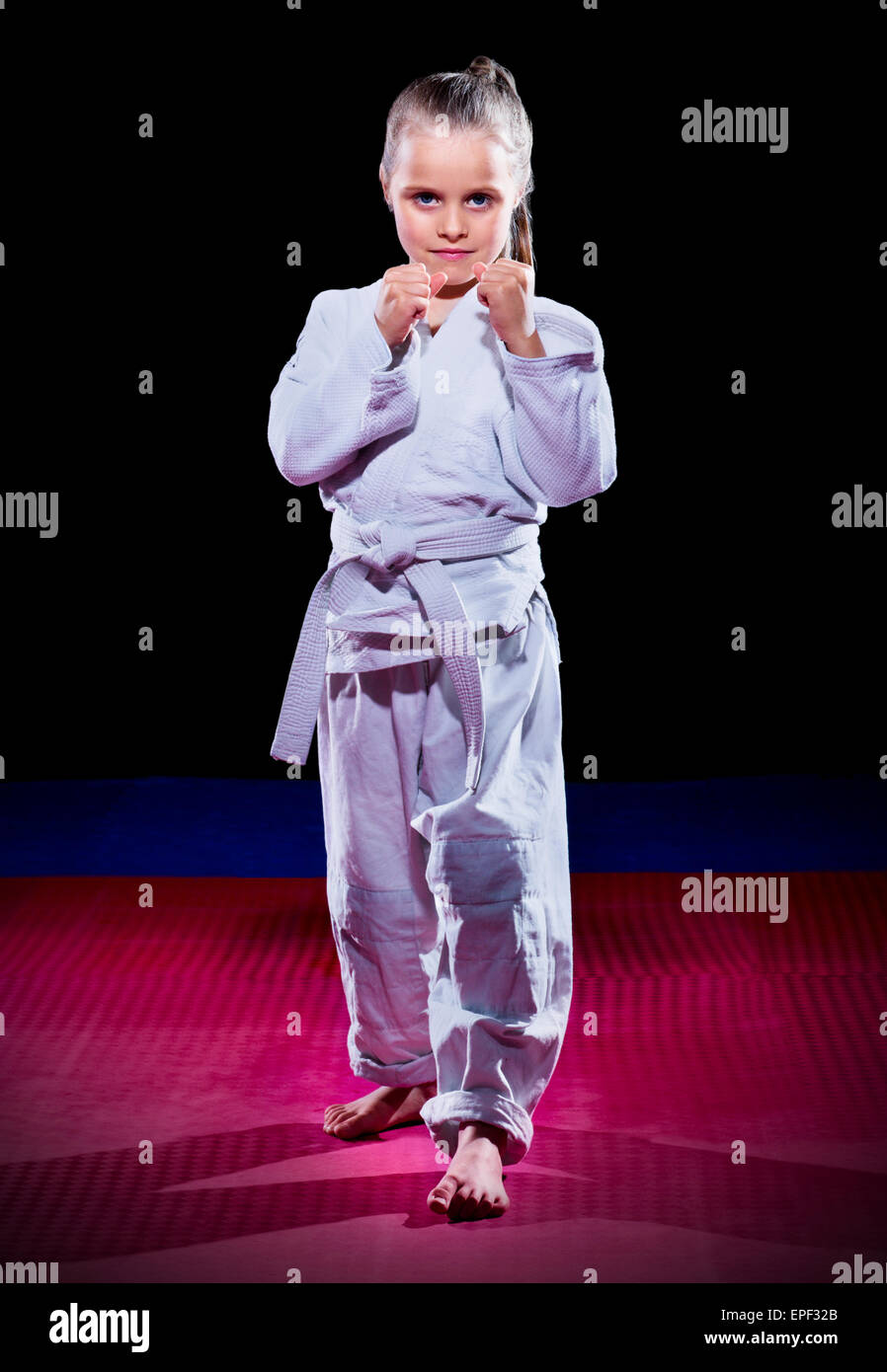 Little girl aikido fighter on black Stock Photo