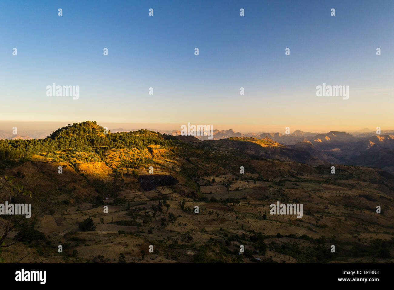 Wide angle view from the Simien Mountains on valleys and highlands in Tigray region, hit by the first golden sunlight. Ethiopia. Stock Photo
