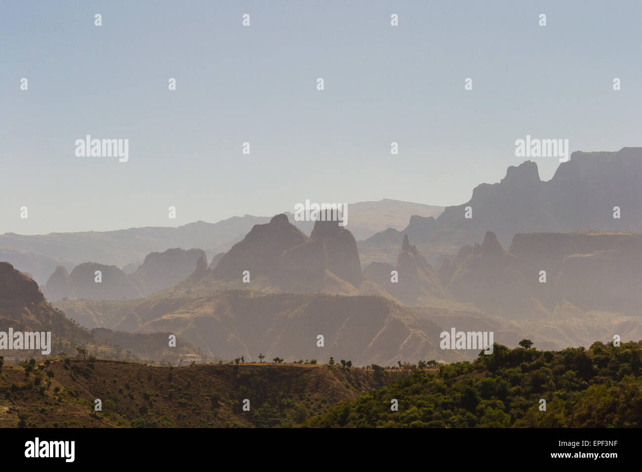 Telephoto view from the Simien Mountains National Park on misty valleys, silhouette of rocky pinnacles and barren highlands. Stock Photo