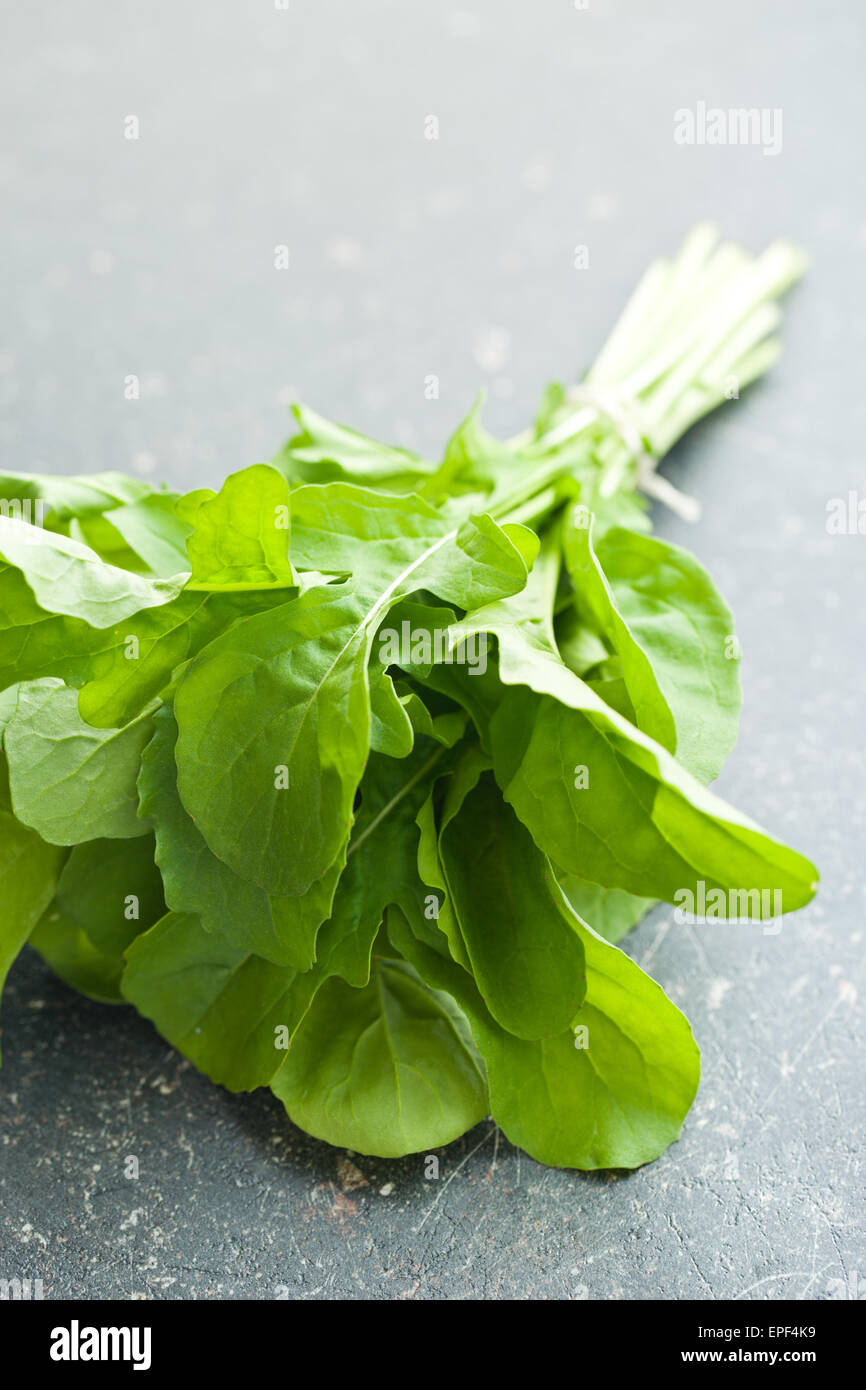 arugula leaves on kitchen table Stock Photo