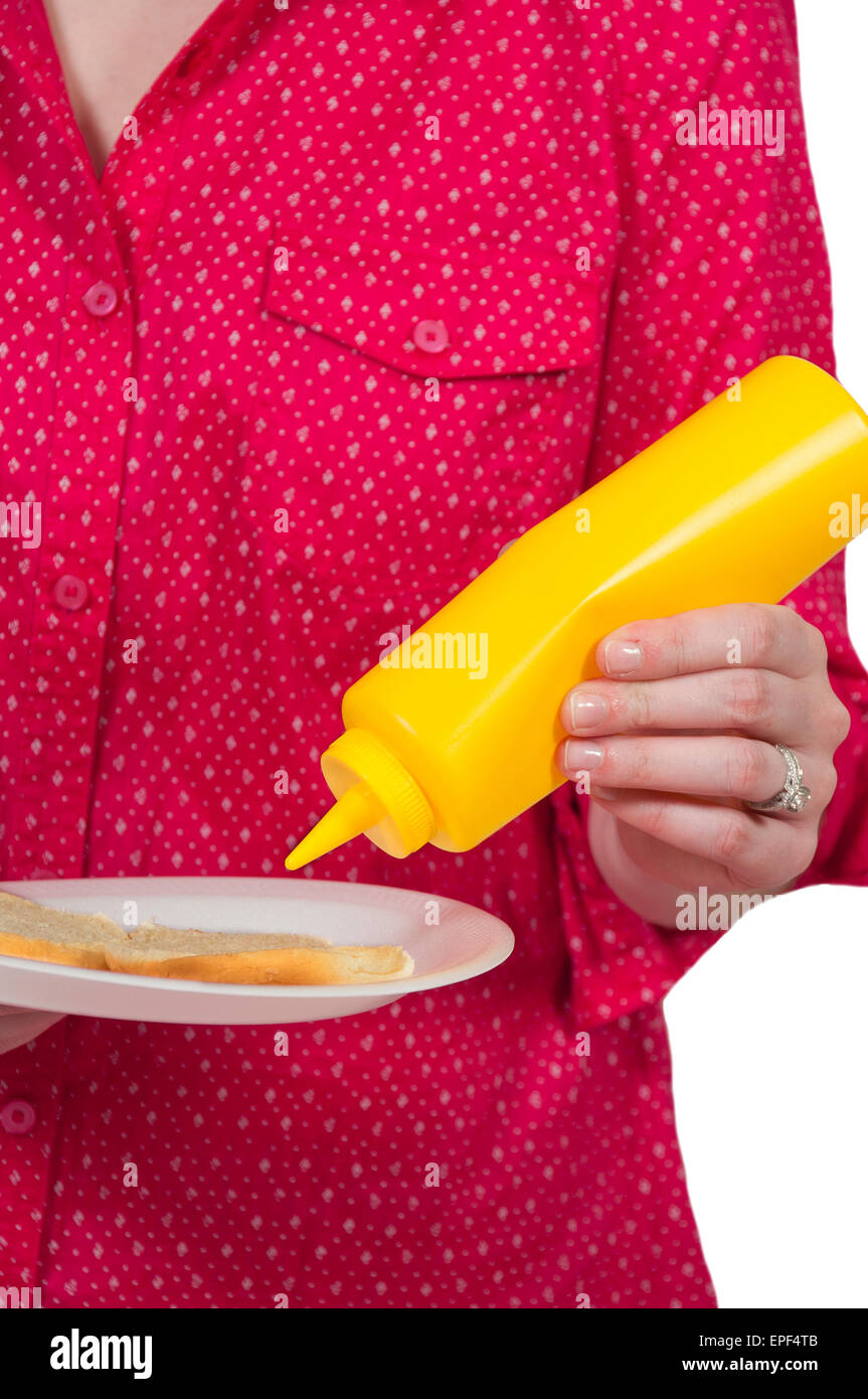 Woman Squeezing Mustard Stock Photo