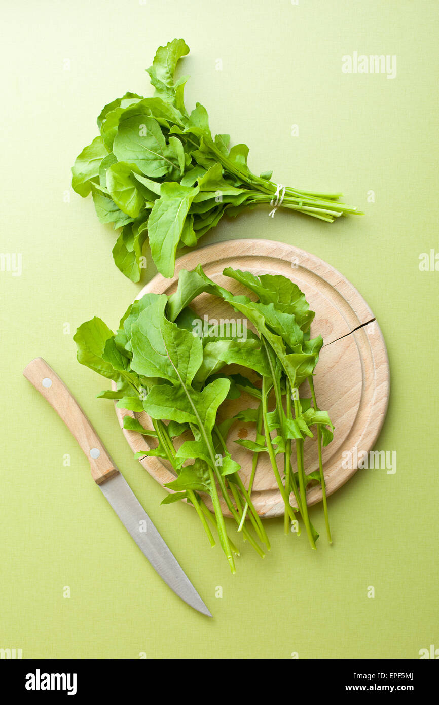 arugula leaves on kitchen table Stock Photo