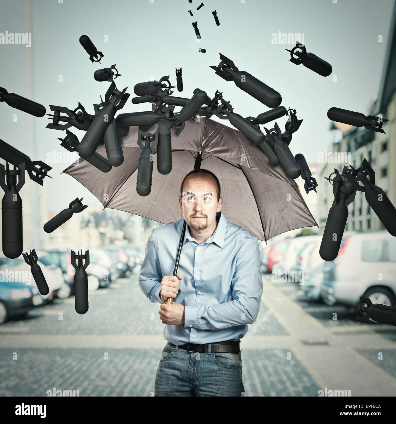 bombs and man try shield himself with umbrella Stock Photo