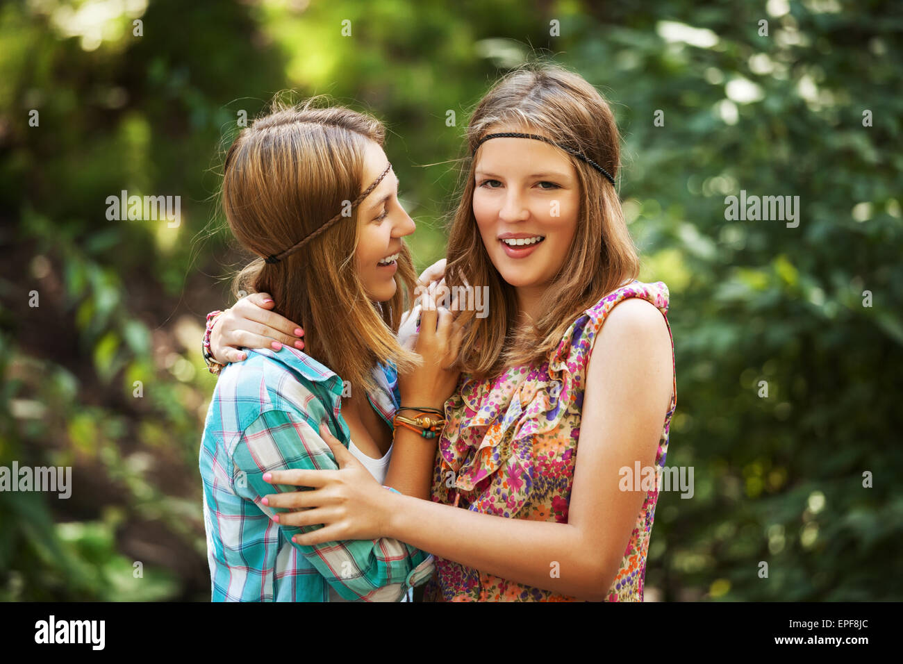 Two happy young girls in a summer forest Stock Photo - Alamy