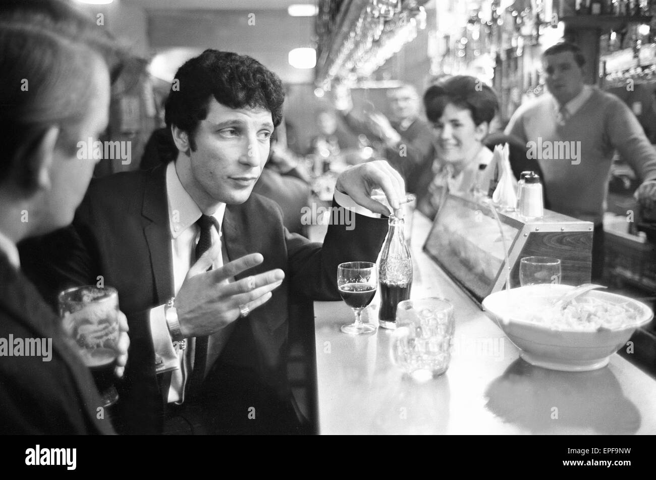 Tom Jones, enjoys a drink, 22nd February 1965. Stock Photo