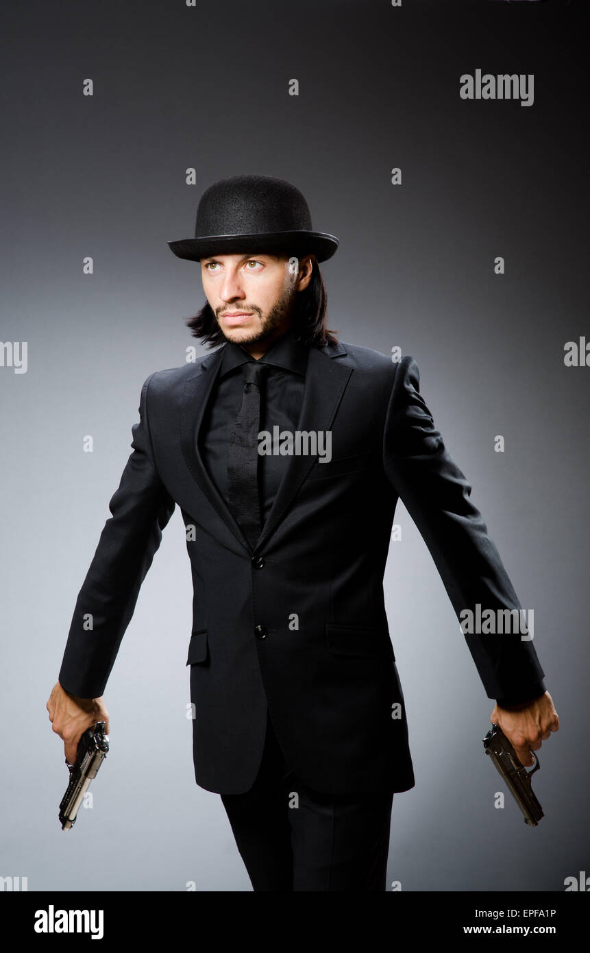 Man wearing vintage hat with gun Stock Photo Alamy