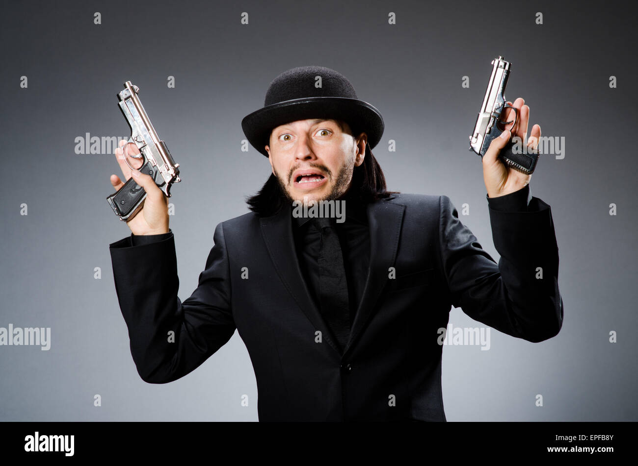 Man wearing vintage hat with gun Stock Photo Alamy