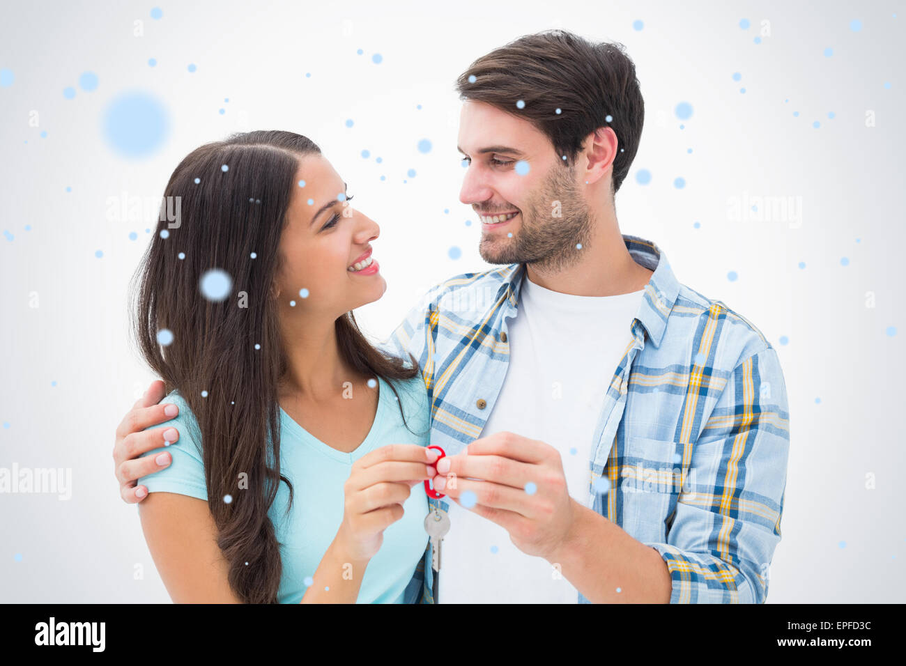 Composite image of happy young couple holding new house key Stock Photo ...