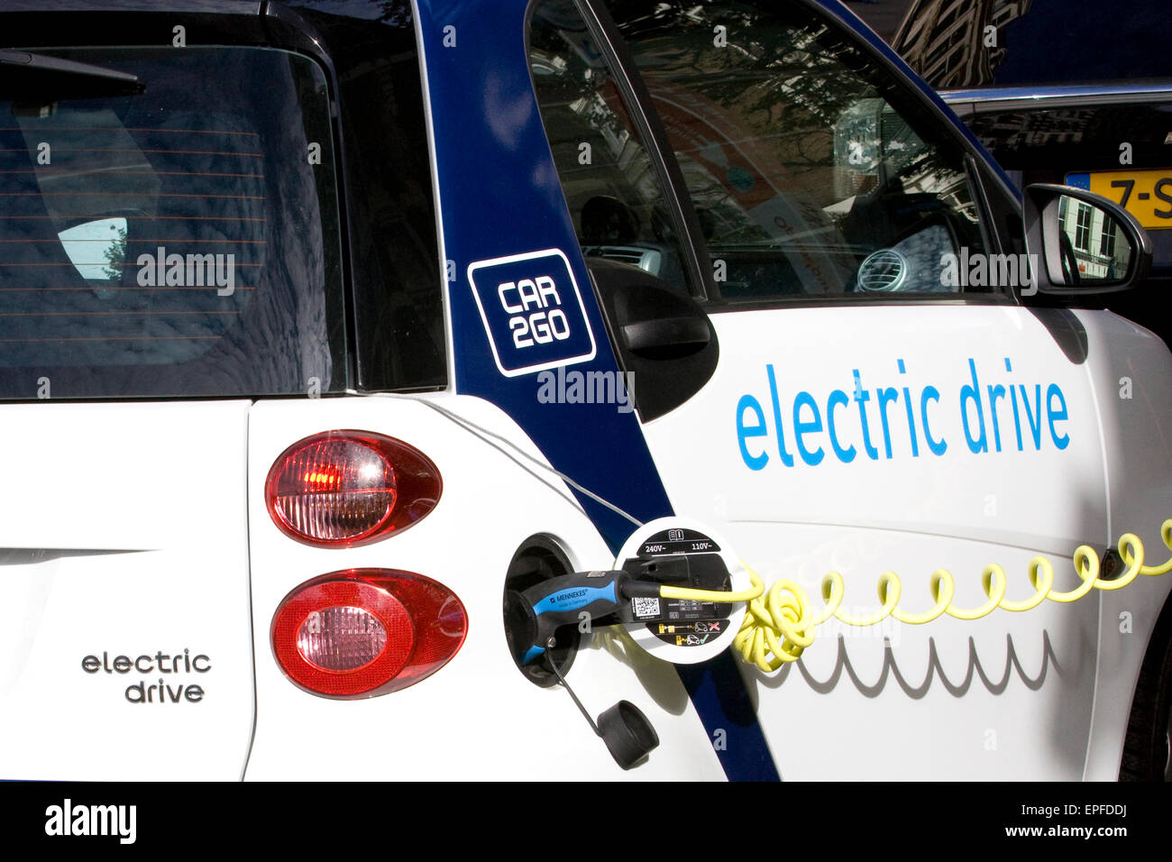 Electric car charging from an on street Electric charge station Stock Photo