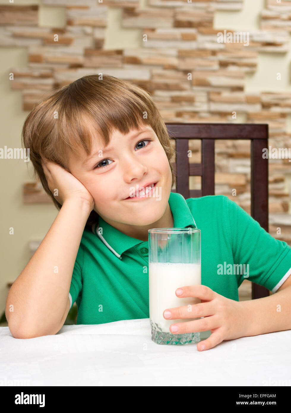 Little boy with milk at the table Stock Photo Alamy