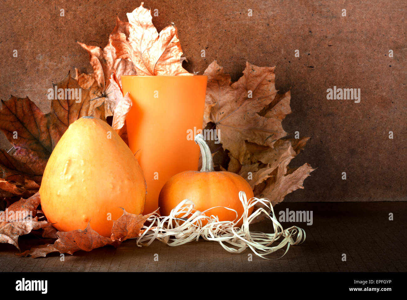 Pile of pumpkins with autumn foliage on abstract background Stock Photo ...