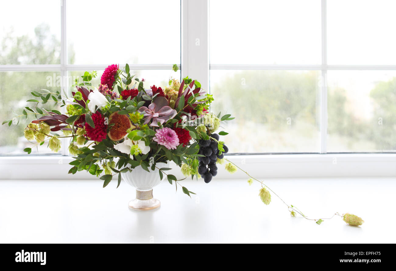 Unusual wedding composition with succulent flowers, grape, fig and hop in retro style Stock Photo