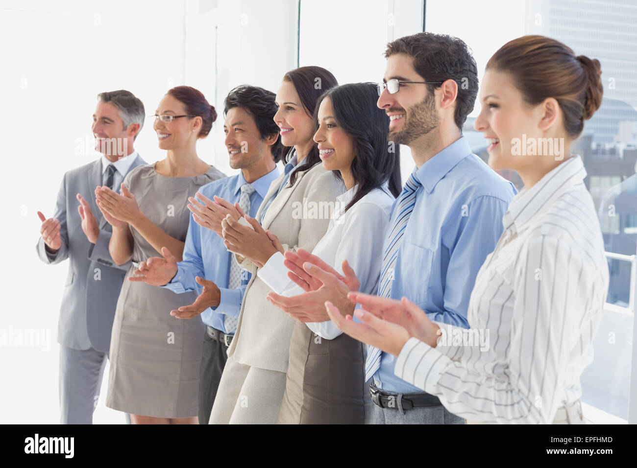 Applauding workers smiling and cheerful Stock Photo