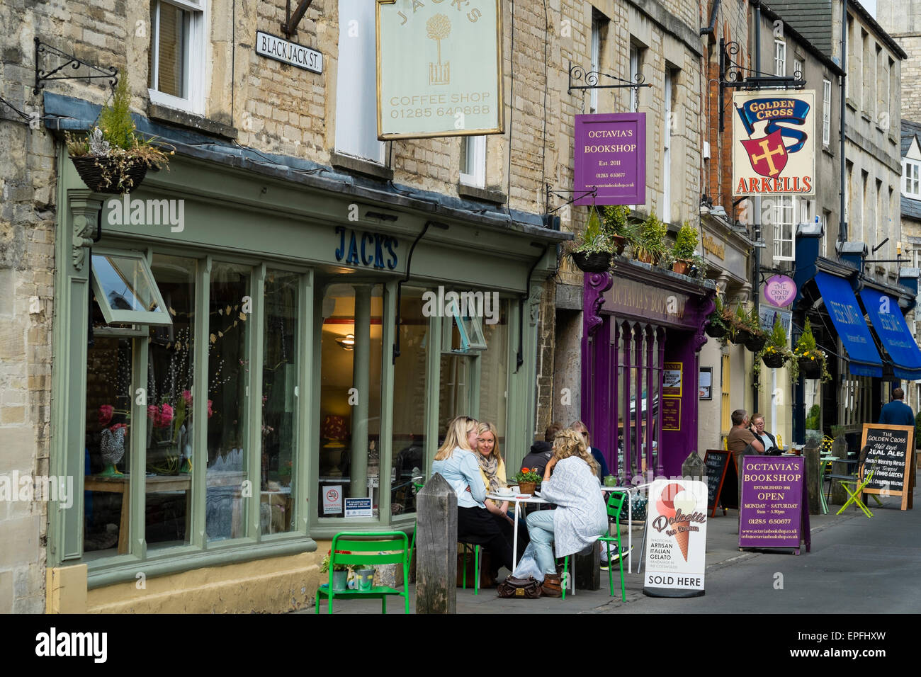 People seated at tables outside Jack's cafe , Blackjack Street, Cirencester, Gloucestershire