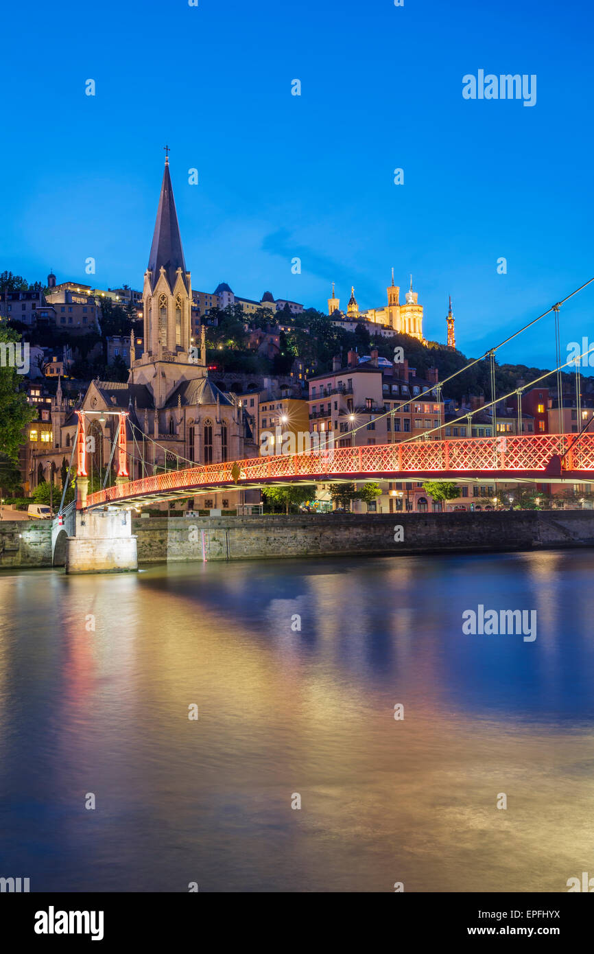 View of Lyon and red footbridge at night, France. Stock Photo