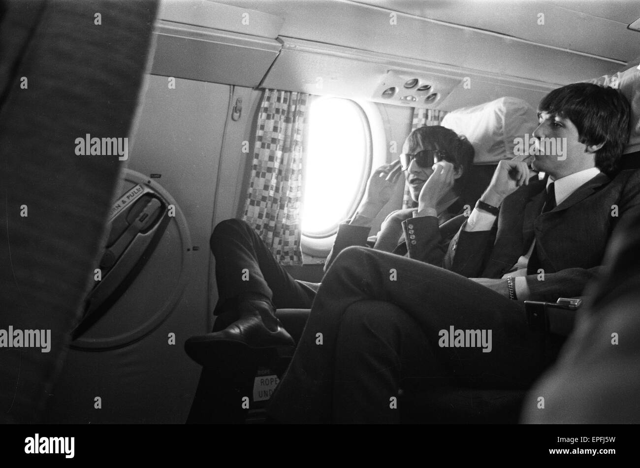The Beatles in Liverpool for the Premier of a Hard Day's Night. Paul McCartney and Ringo Starr pictured here on the plane on the journey to Liverpool. 10th July 1964. Stock Photo