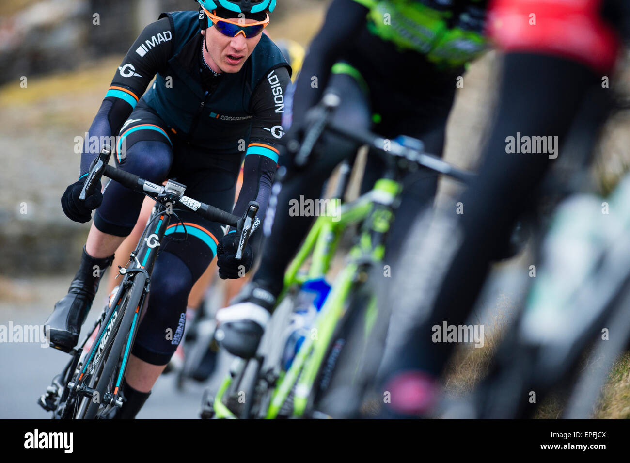 Male cyclists cycling in a competitive professional cycle race, UK