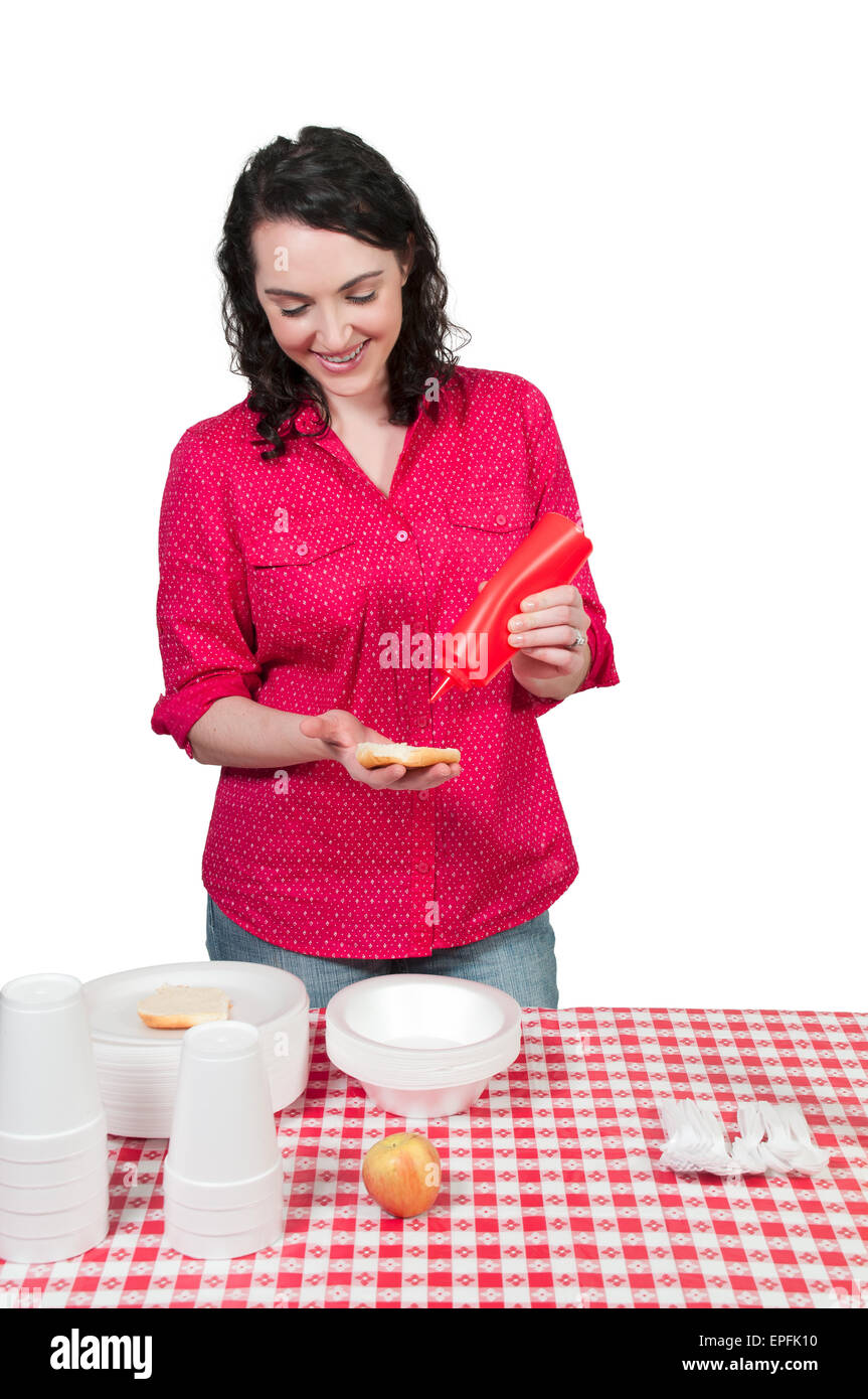 Woman Squeezing Catsup Stock Photo