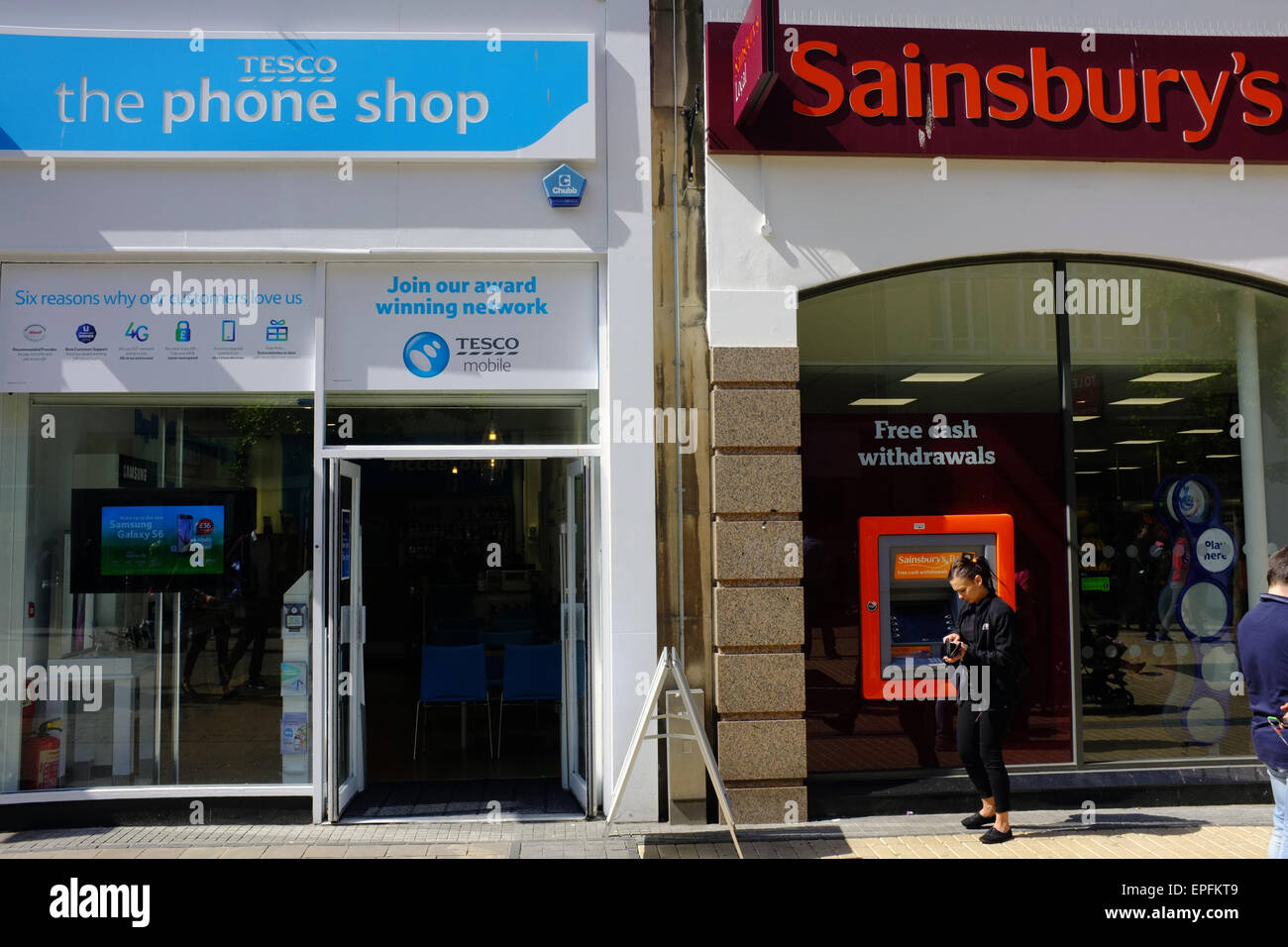 A Tesco phone shop next to a Sainsbury's shop in the central of Bristol