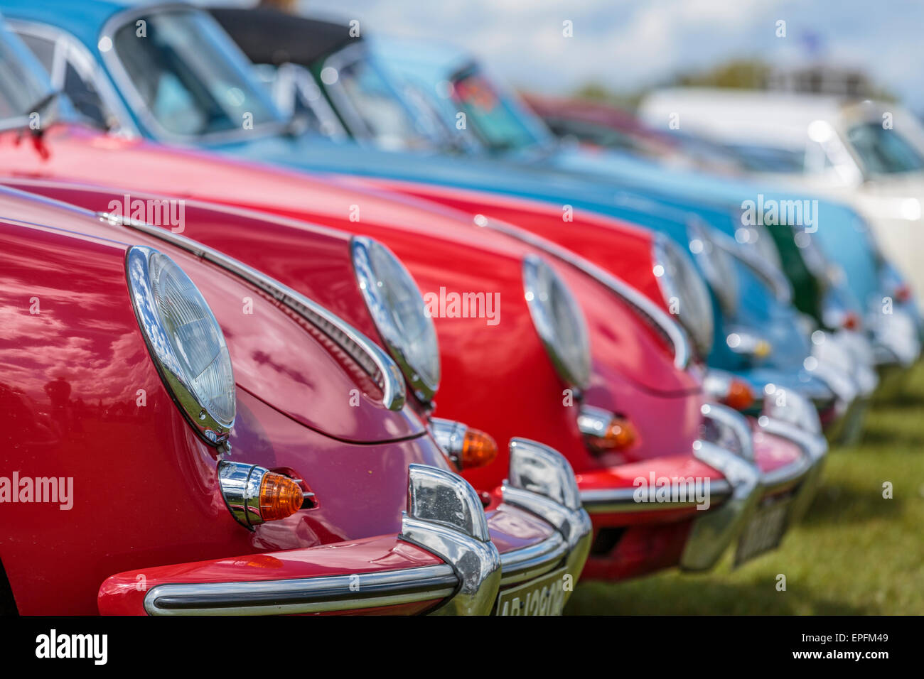 Close up image of the beautiful lines and chrome headlamps and bumpers of a collection of collectors Porsche 356 classic sports cars,  England, UK Stock Photo