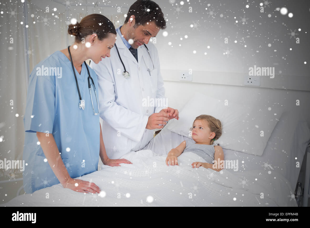 Composite image of doctors attending little girl Stock Photo - Alamy