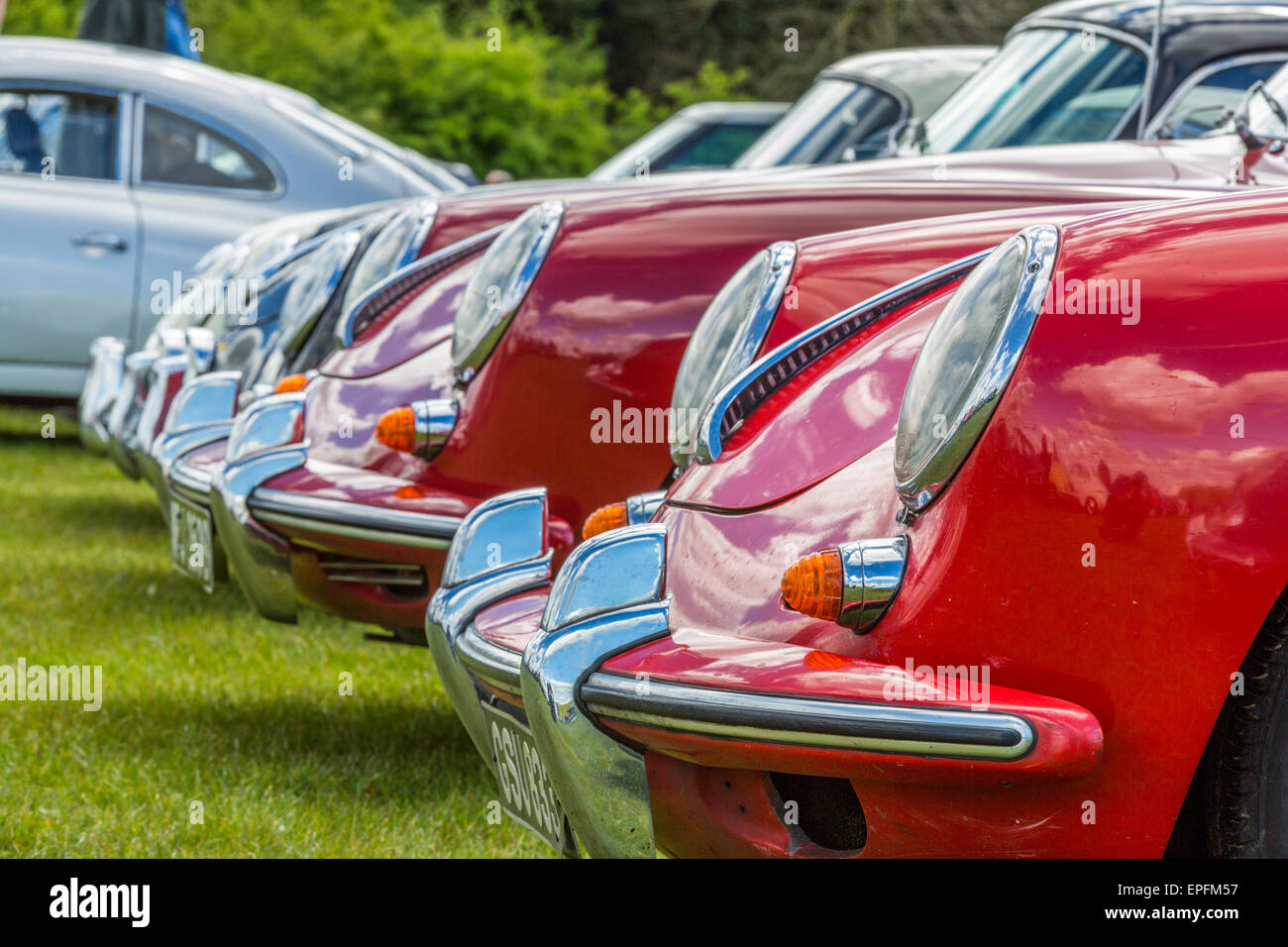 A portrait image of the headlamps of a collection of Porsche 356 classic sports cars Bedfordshire England UK Stock Photo