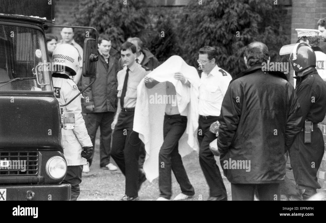 Strangeways Prison Riot 2nd April 1990. Injured prisoner is led away.  A 25-day prison riot and rooftop protest at Strangeways Prison in Manchester, England. The riot began on the 1st April 1990 when prisoners took control of the prison chapel, and the ri Stock Photo