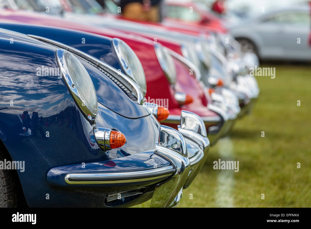 A landscape image of the headlamps of a collection of Porsche 356 classic sports cars, Bedfordshire England UK Stock Photo